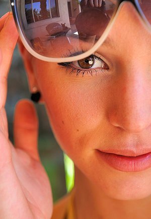 Skinny blonde in a sexy two-piece shows her body while outdoors