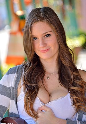 Brown-haired babe with a winning smile plays guitar with her tits out