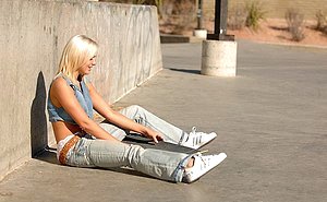 Slim blonde with big natural boobs posing like a true skater girl