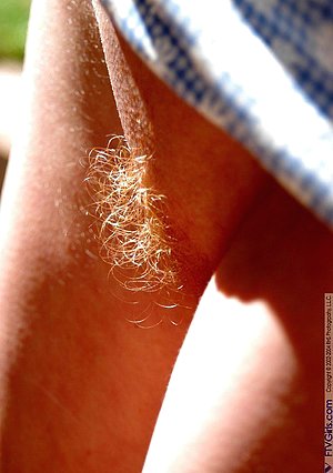 Beauty with a bush showing her ginger pubes in an outdoor posing gallery