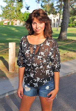 Big-haired brunette doing cartwheels outdoors and teasing her wet puss
