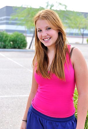 Stacked redheaded teen posing in the kitchen, flashing her pussy in public