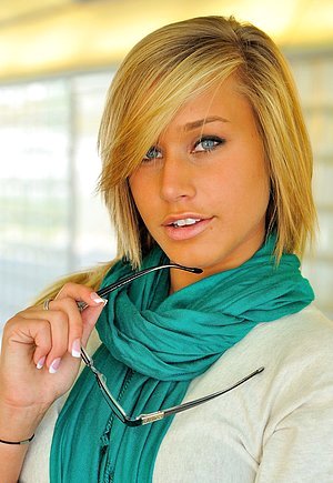 Elegant blonde in sexy glasses fingering her pussy in front of the cam